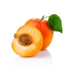 Ripe apricot fruits with with green leaf and slice isolated